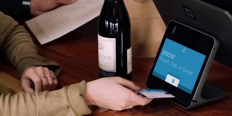 person playing card on POS machine