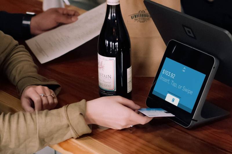 person playing card on POS machine