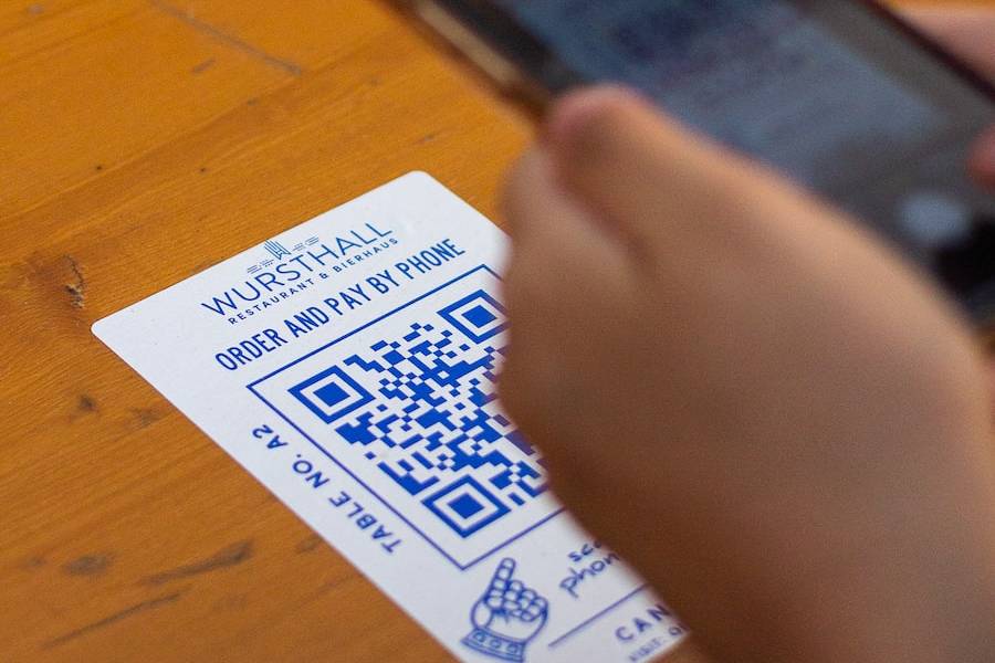 person holding white and black card