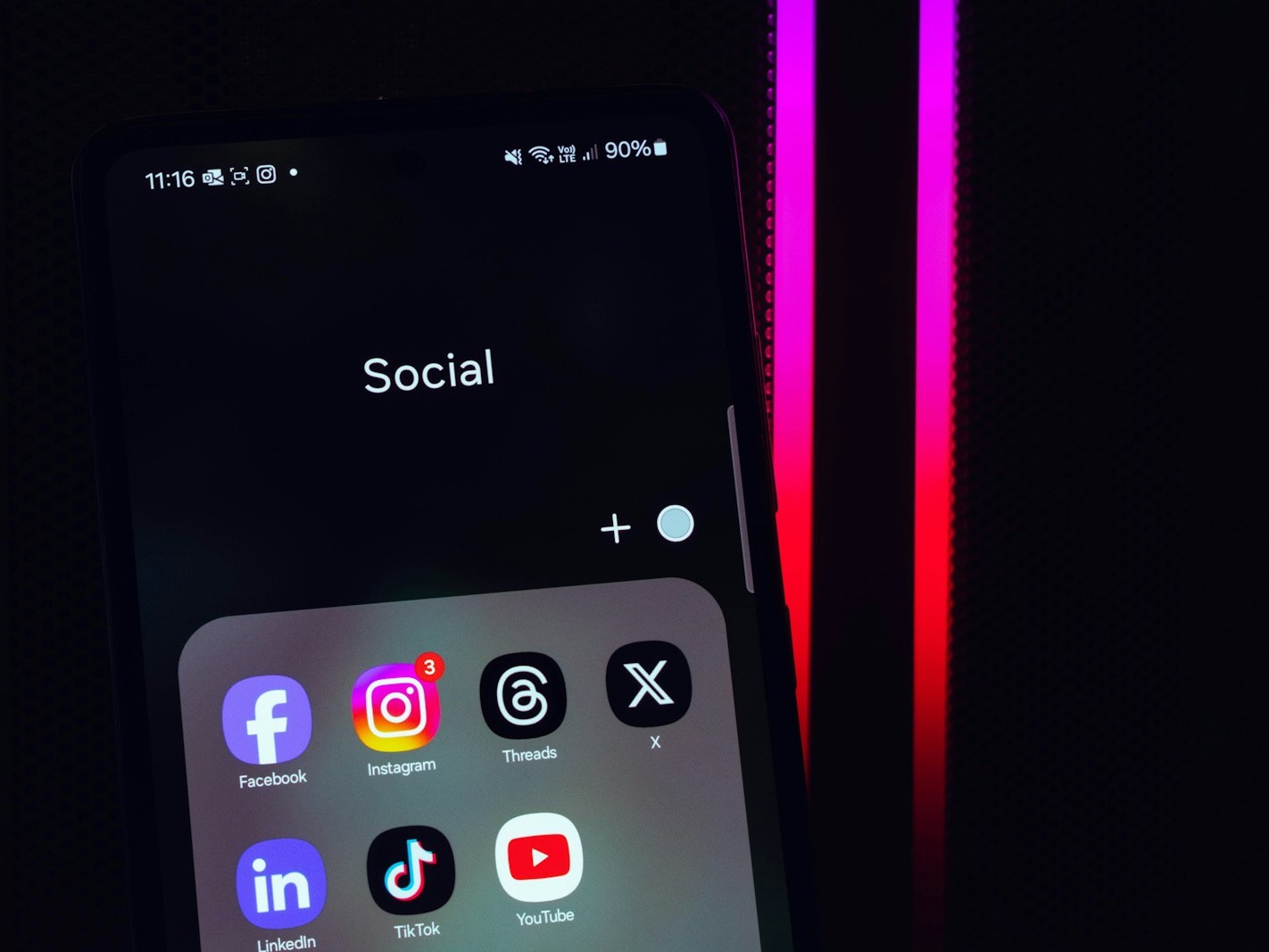 a close up of a cell phone with social icons on it